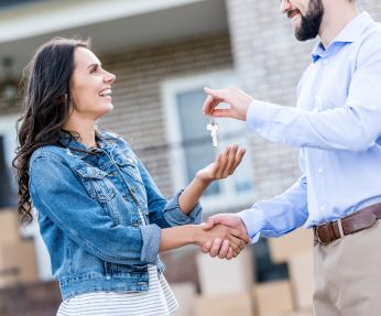 Closing Lawyer in Garden City, NY Handing Keys to a New Homeowner